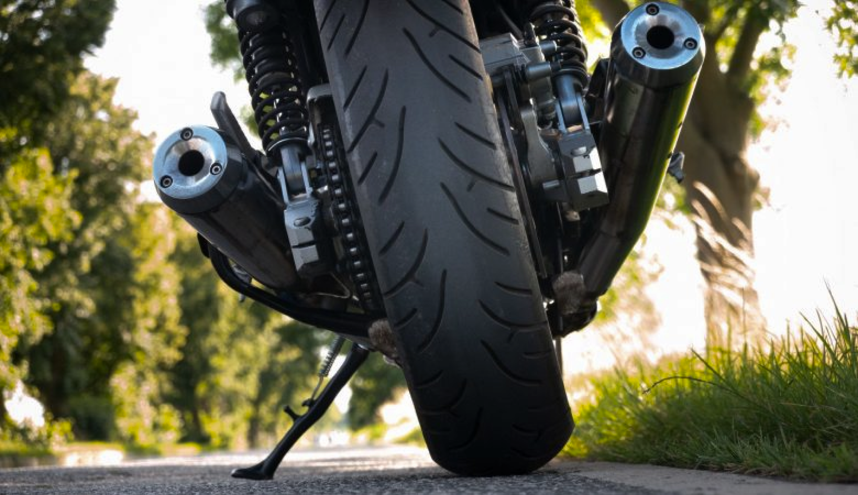 motorcycle viewed from the rear showing exhaust pipes